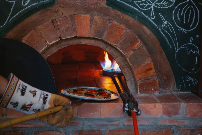 Pizzana restaurant interior with warm ambiance and wood-fired oven